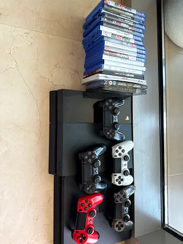Two PS4 consoles with 5 controllers and 15+ PS4 games - good working condition