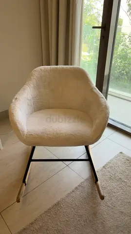 Cozy white upholstered armchair with metal frame — used