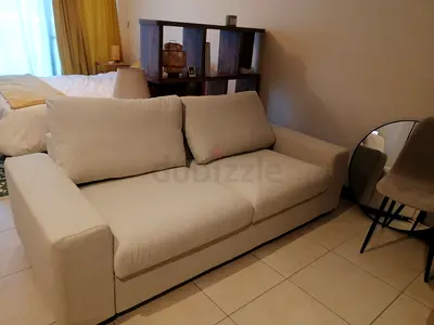 Beige 2-seater fabric sofa in good condition
