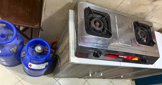 Two-burner stainless gas stove with 2 gas cylinders( 1 full and other one used)