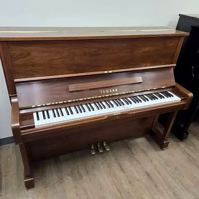 Yamaha U1 walnut color Japan made with matching piano bench. Free delivery and tuning with warranty.