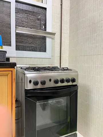 Used stainless steel gas cooker with oven — good working condition