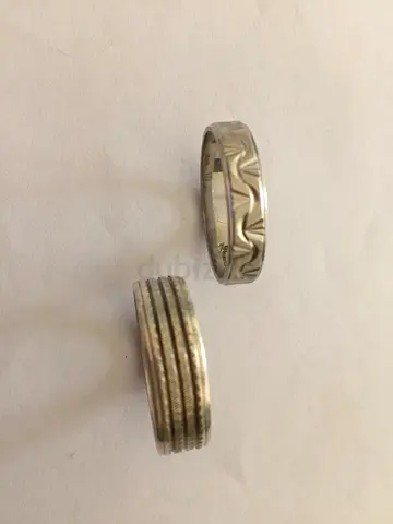 Two mens metal rings with textured and patterned designs - used