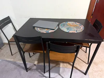 Compact black dining table with 4 chairs - good condition