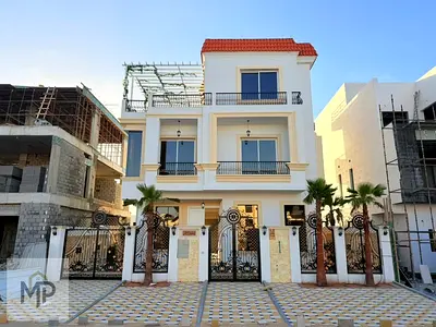 Two-story villa with a rooftop terrace and swimming pool at a special price, including electricity, water, and air conditioning, in one of Ajman's mos