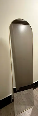 Full-length freestanding arched mirror with slim gold frame