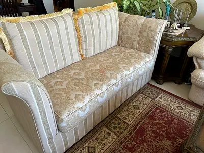 Two-seater vintage cream patterned sofa in good condition