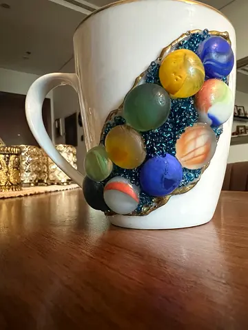 Handmade decorative ceramic mug with colorful bead embellishments