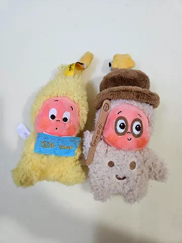Two soft plush character toys — small cuddly plushies (lightly used)