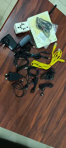 Bundle of assorted electronic adapters, chargers, cables and router/accessory