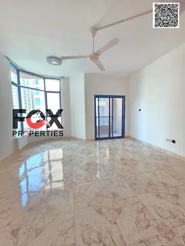 For annual rent in Ajman: a three-bedroom apartment with a living room, balcony, four bathrooms, and built-in wardrobes.