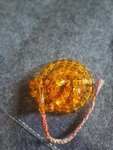 Amber-colored prayer beads (tasbih) with braided tassel
