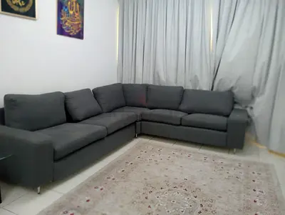 Dark grey L-shaped sofa - good condition, comfortable seating