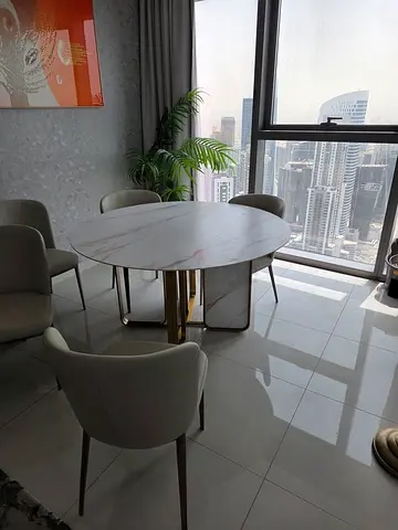 Round white marble-effect dining table with 6 upholstered chairs