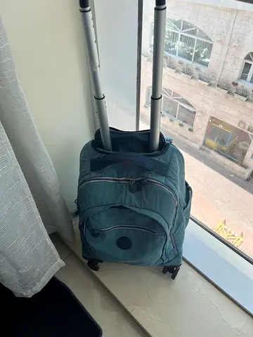 Used small wheeled Kipling backpack / trolley bag with extendable handle - teal in v good condition