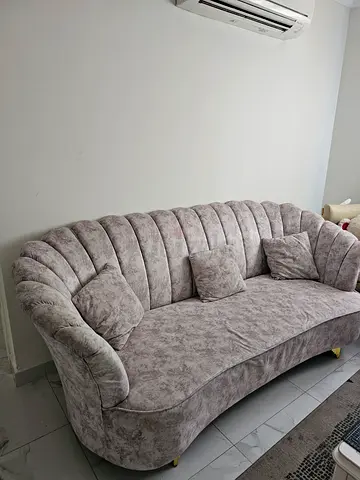 Light grey three-seater upholstered sofa in good condition