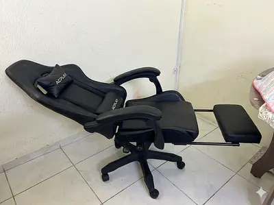 Black ergonomic reclining office/gaming chair with footrest