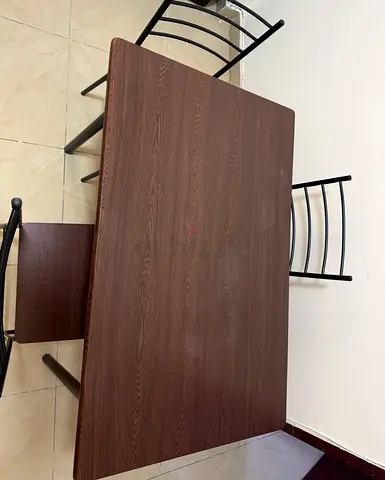 Simple dark-wood dining table with 4 metal chairs