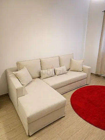 Beige L-shaped 3-seater Sofa with Chaise and storage space along with extending bed