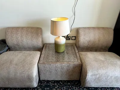 Pair of armless lounge chairs with matching side table and lamp