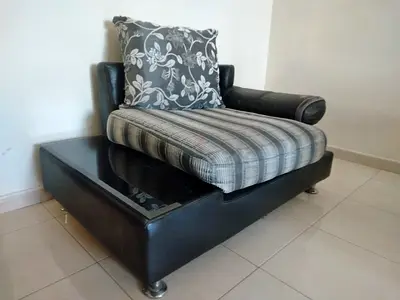 Single modern black leather lounge chair with removable cushions