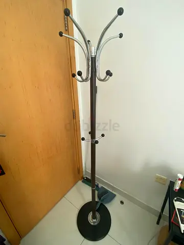 Free-standing coat rack with chrome hooks and dark wood finish