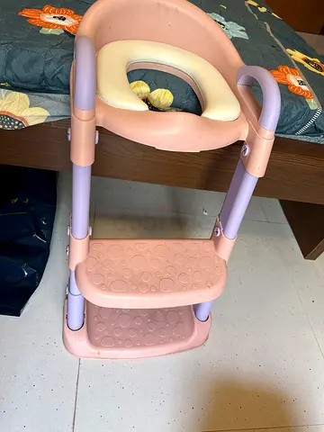 Pink toddler step stool with built-in handle and non-slip surface