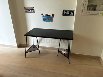 Simple black writing desk with metal frame