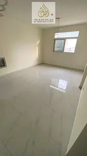 A two-bedroom apartment with a hall available for annual rent in Al Jurf 2, located next to Al Natio