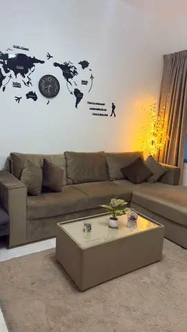 L-shaped beige color sofa with 4-piece cushions and coffee table