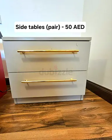 Pair of beige bedside/side tables with gold handles - 50 AED
