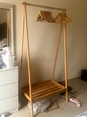 Light wooden freestanding clothes rack with hangers
