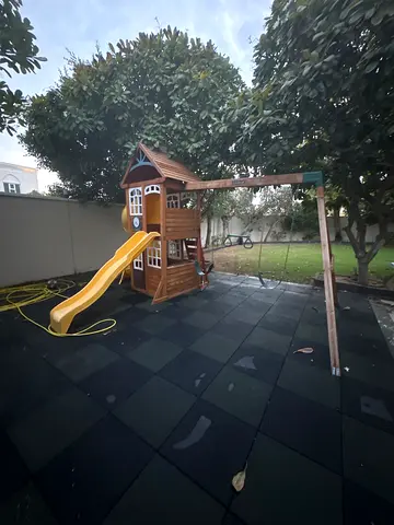 Wooden kids playhouse with slide and swing frame