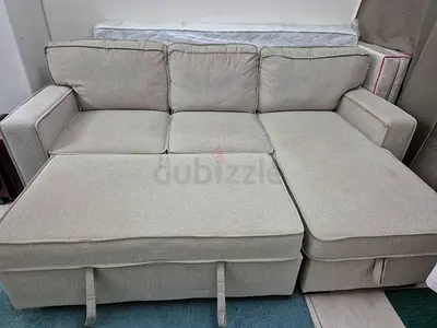 Light grey L-shaped fabric sofa with storage chaise — good condition