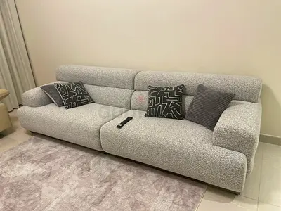 Modern Light Grey 3-Seater Sofa – Cozy Bouclé Fabric and a beige leather sofa