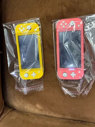 Two Nintendo Switch Lite consoles (Coral  Yellow) - Good condition, unused-looking