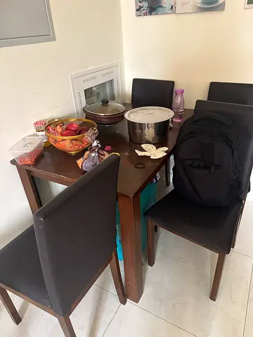 4-seater wooden dining table with upholstered chairs