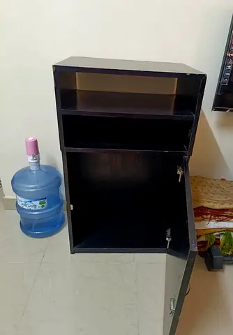 Compact dark wood storage cabinet with shelves and cupboard