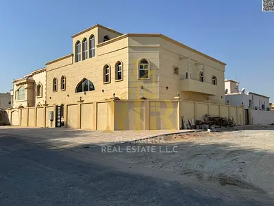 Corner villa for sale in Al Muwaihat 3 | 8000 sq ft | Two floors + roof | 4 independent apartments | 12 master bedrooms | Suitable for 4 families | Pr