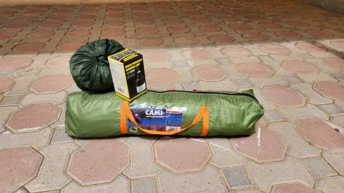 Camping set including tent, sleeping bag, and emergency light.