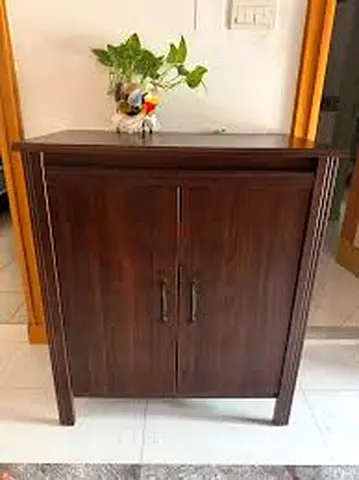 Compact dark wood storage cabinet with double doors — good condition