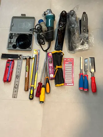 Mixed woodworking and metalworking hand tools set — chisels, planes, grinders, hammers, screwdrivers