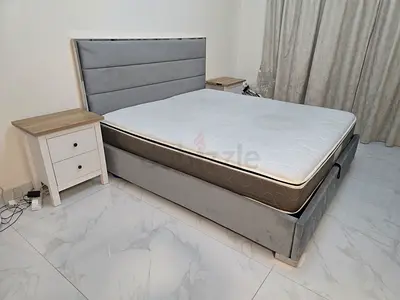 King size upholstered bed frame with mattress and bedside tables