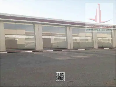 An opportunity for investors: A commercial building in Ajman, Al Helio, consisting of 4 shops and a mezzanine. Freehold ownership. Located on a paved