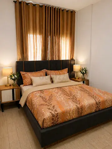 King upholstered bed frame with headboard and mattress in dark grey with two side tables