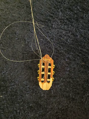 Classical acoustic guitar headstock with tuning pegs and strings (needs restringing)