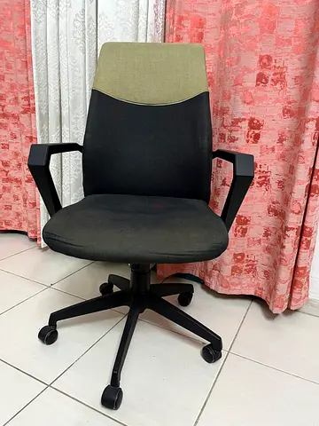 Used ergonomic office chair with armrests and caster wheels