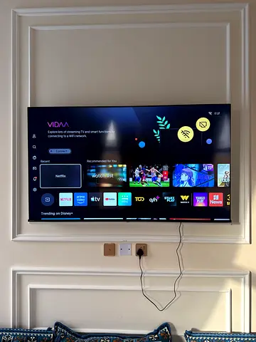 65 inch LED Smart TV mounted on wall - brand new condition