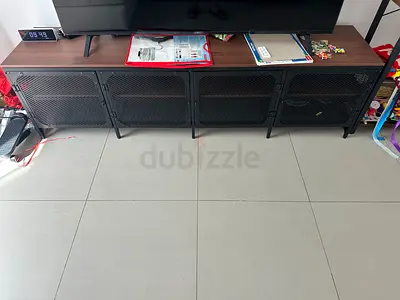 Long industrial-style TV console cabinet with wood top and metal mesh doors