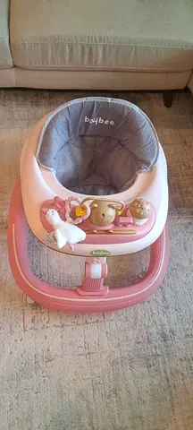 Used pink baby walker/jumper - comfortable seat, toy bar included
